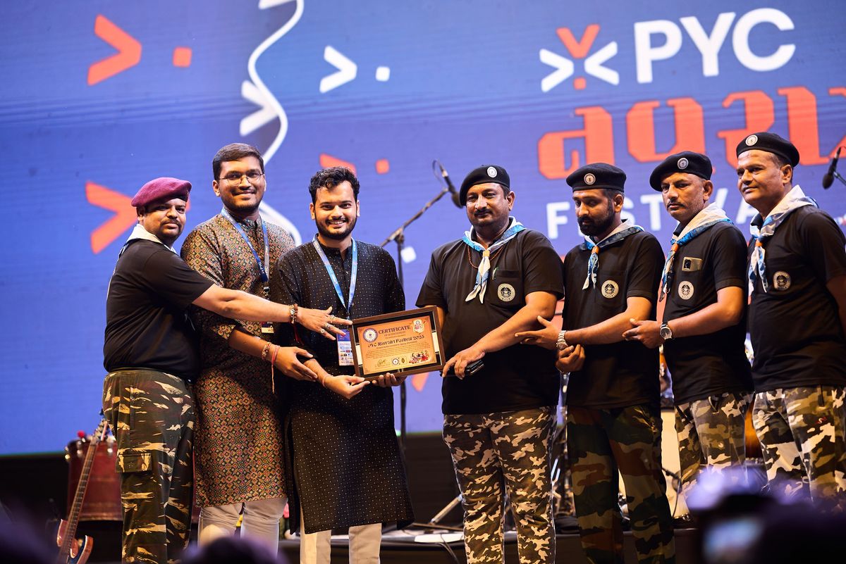Team PYC receiving the Best Organised Navratri Festival award on stage